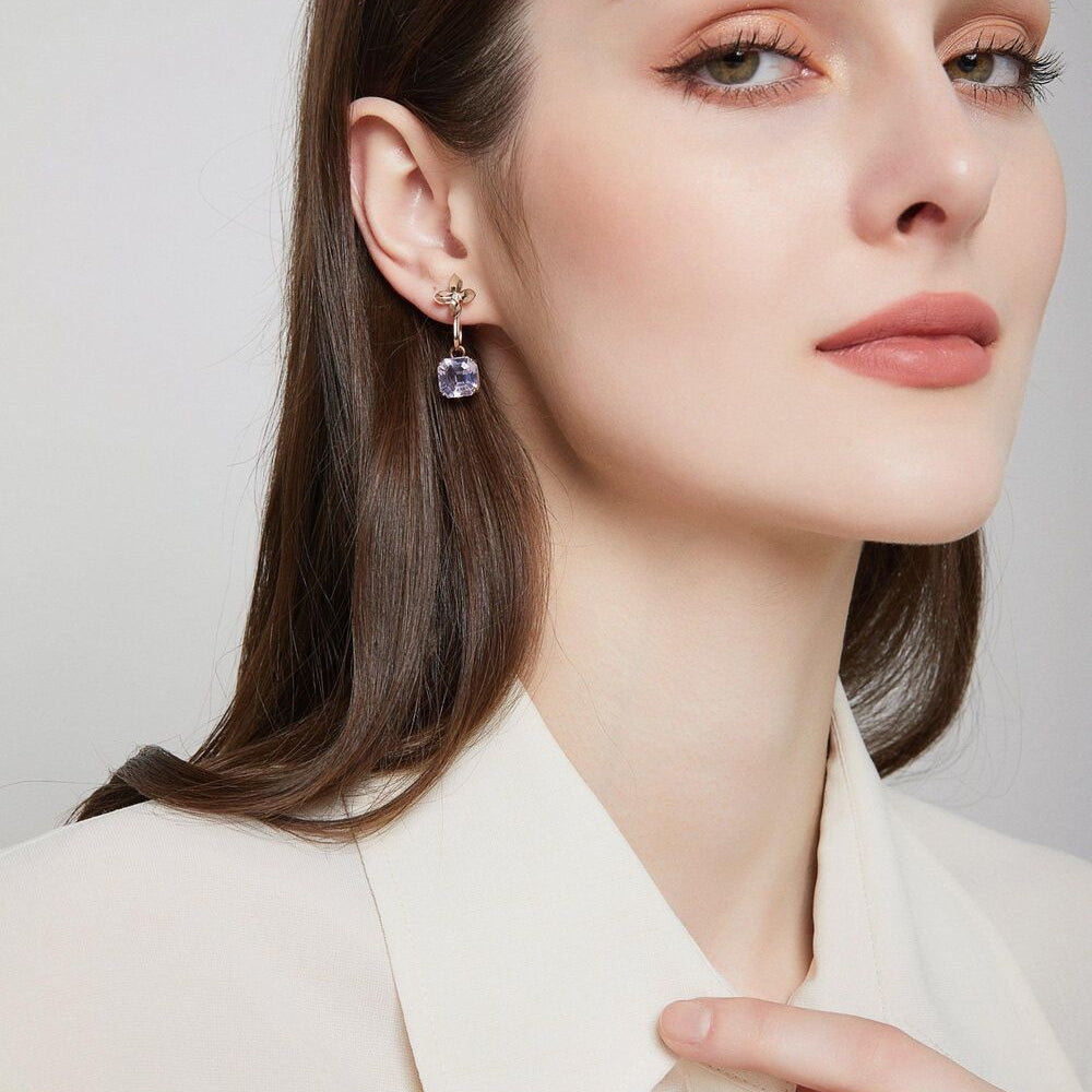 A model wearing Tyche Grace 14K gold amethyst earrings